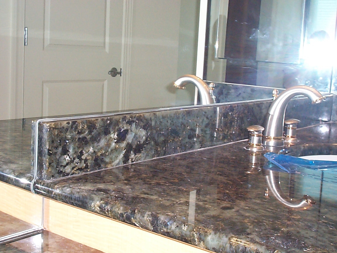 detail of mirror cut around granite top